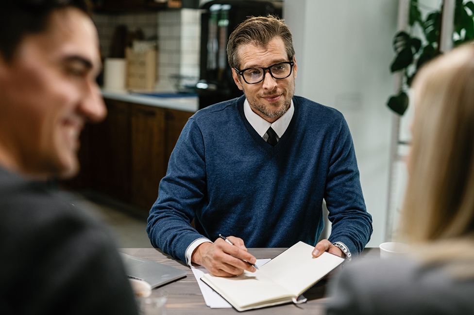 Male advisor writing in a notepad